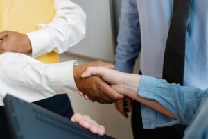a-close-up-of-two-people-shaking-hands