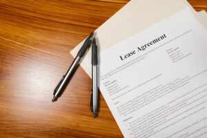 lease-agreement-on-wooden-surface-with-folder-and-pens
